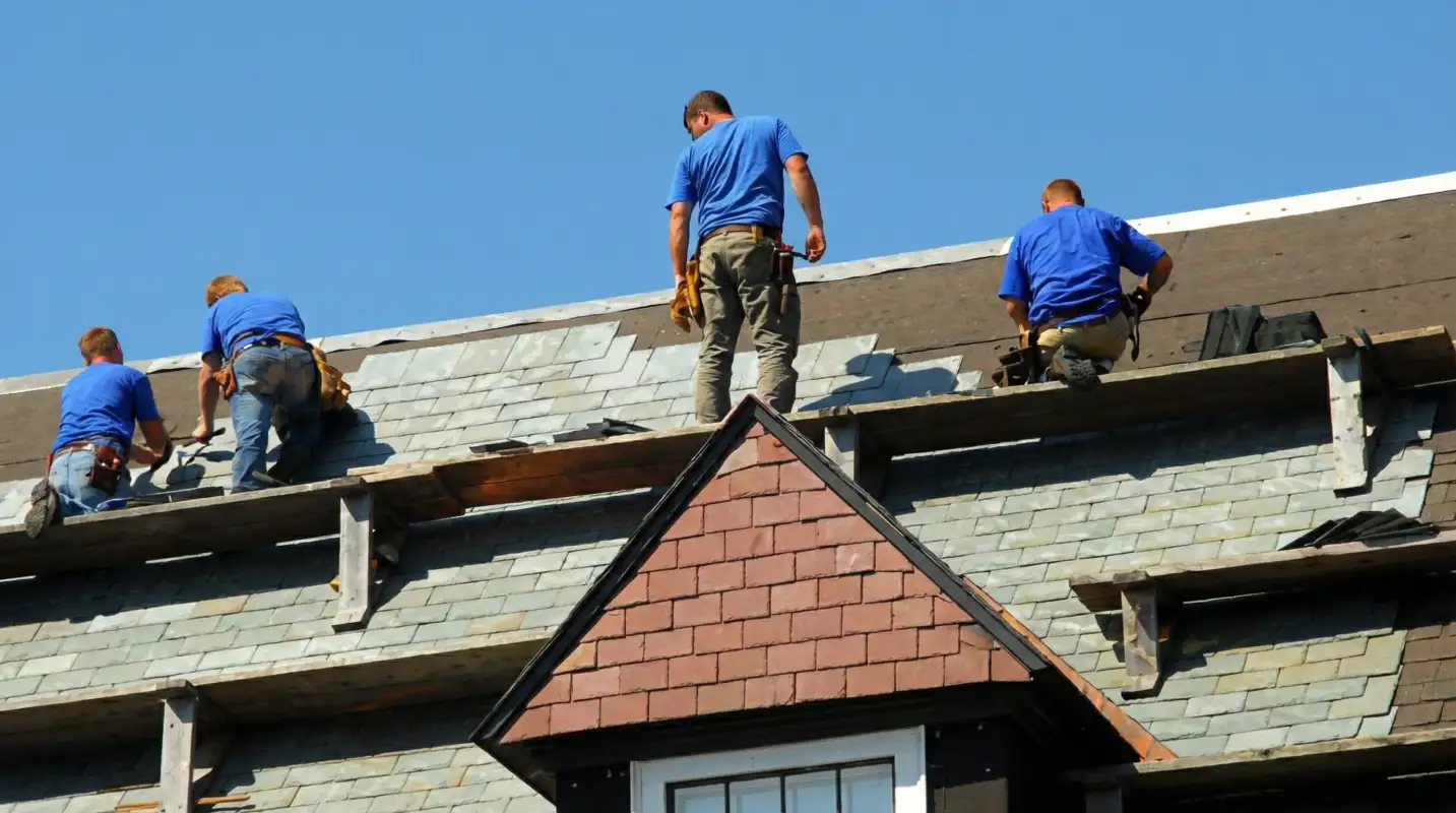 Roof replacement in progress with a team of professional contractors installing new shingles on a residential home in Fresno, CA