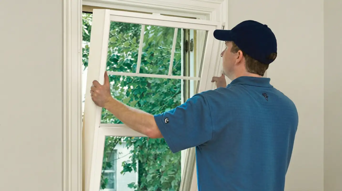 Professional contractors performing a residential window insulation and replacement service in Fresno, CA